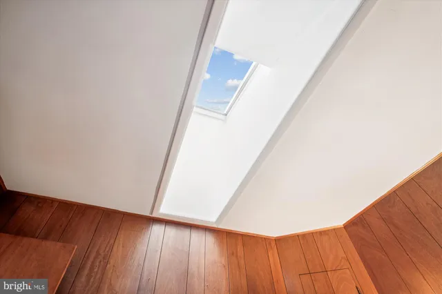 a view of a room with wooden floor