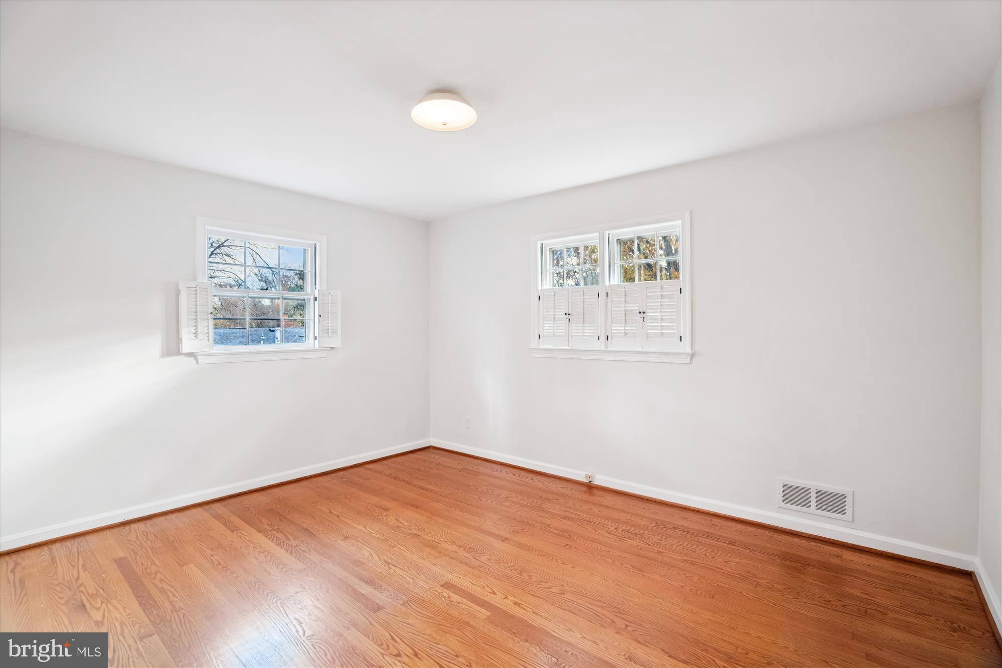 1912 Kimberly Road Silver Spring, MD 20903 - Photo 25 of 45 an empty room with wooden floor and window