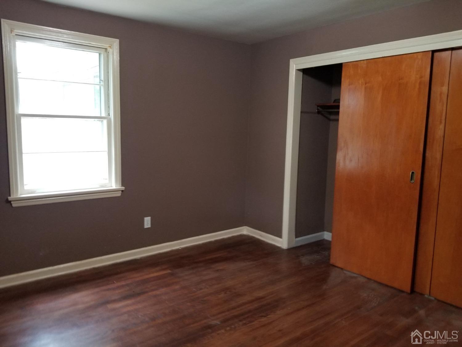 672 Hermann Road North Brunswick, NJ 08902 - Photo 4 of 15 an empty room with wooden floor and entrance