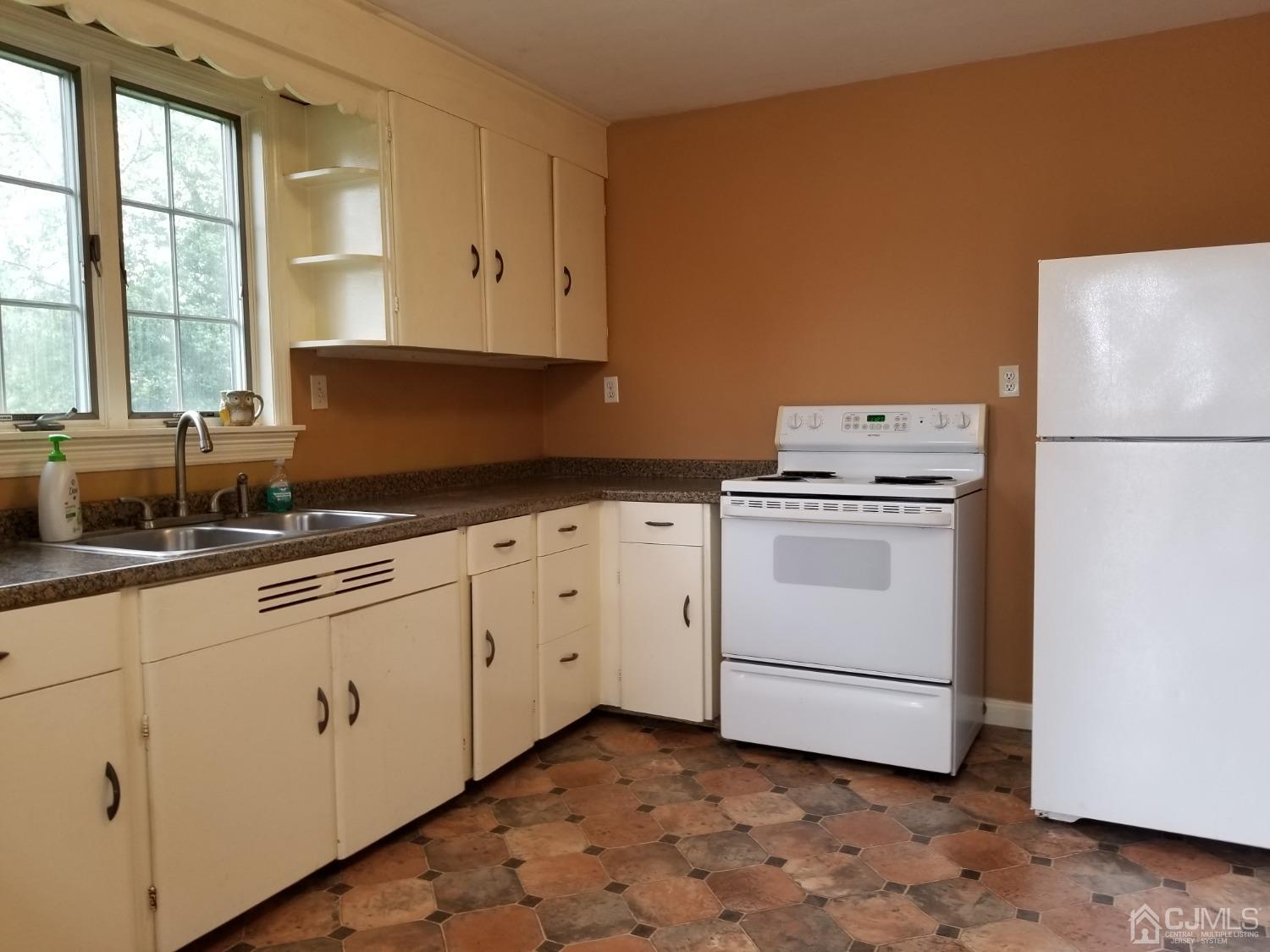 672 Hermann Road North Brunswick, NJ 08902 - Photo 8 of 15 a kitchen with cabinets appliances and a window