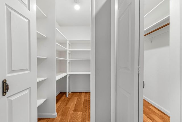 a view of walk in closet with empty racks