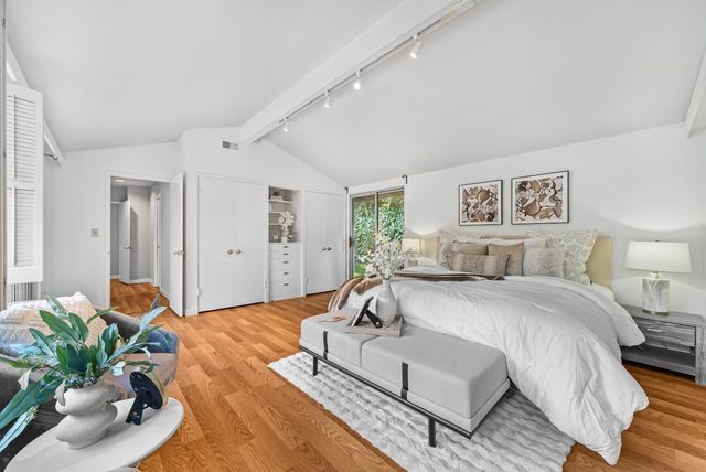 a spacious bedroom with a bed and a couch