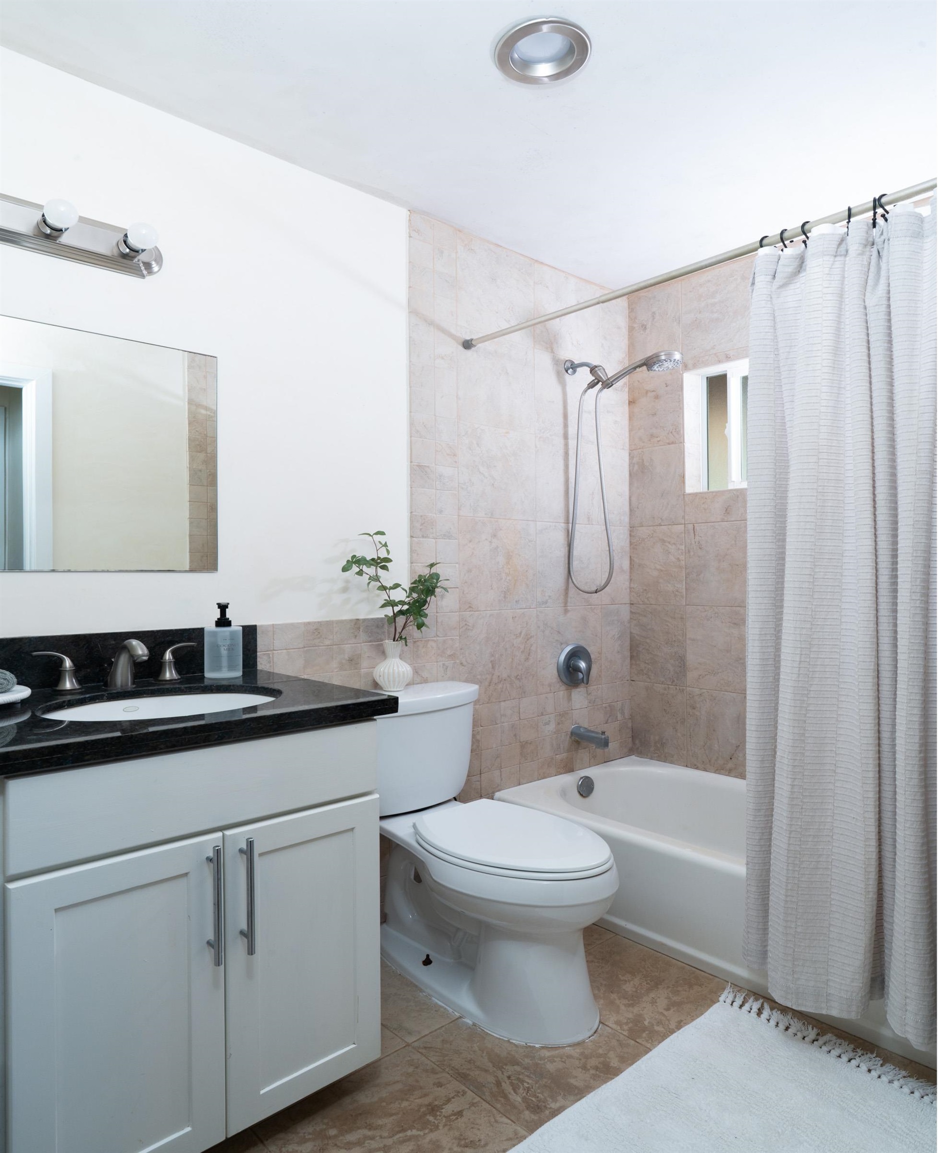 4509 Opana Place Haiku, HI 96708 - Photo 17 of 31 a bathroom with a granite countertop sink a toilet and shower