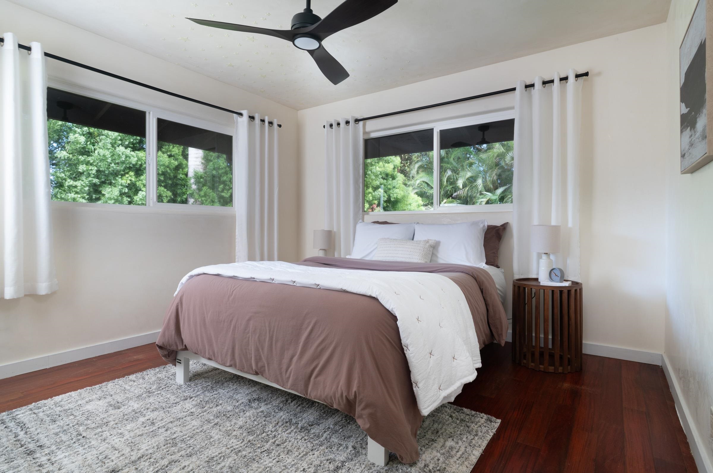 4509 Opana Place Haiku, HI 96708 - Photo 18 of 31 a bed sitting in a bedroom next to a window