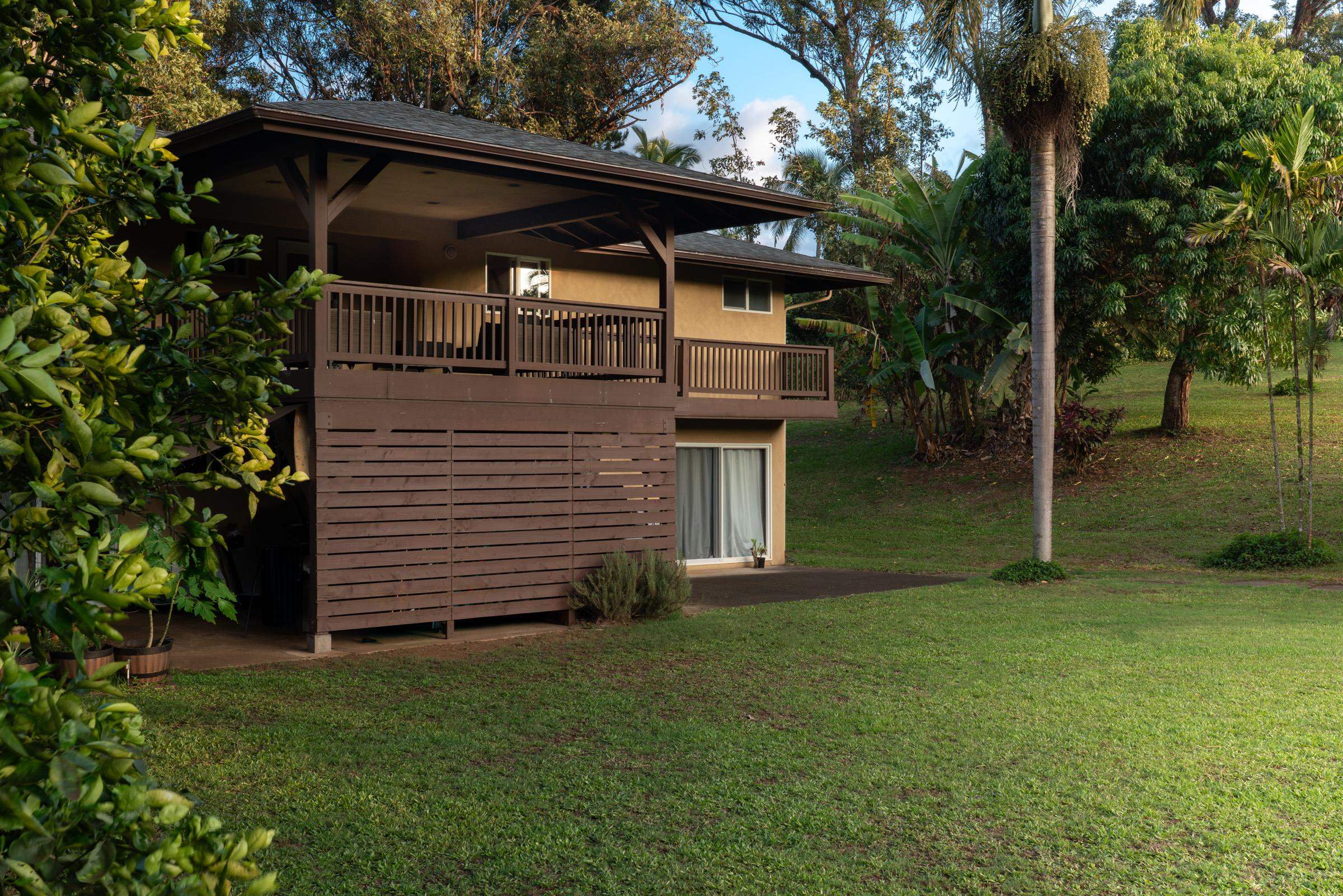 4509 Opana Place Haiku, HI 96708 - Photo 22 of 31 a front view of a house with a garden