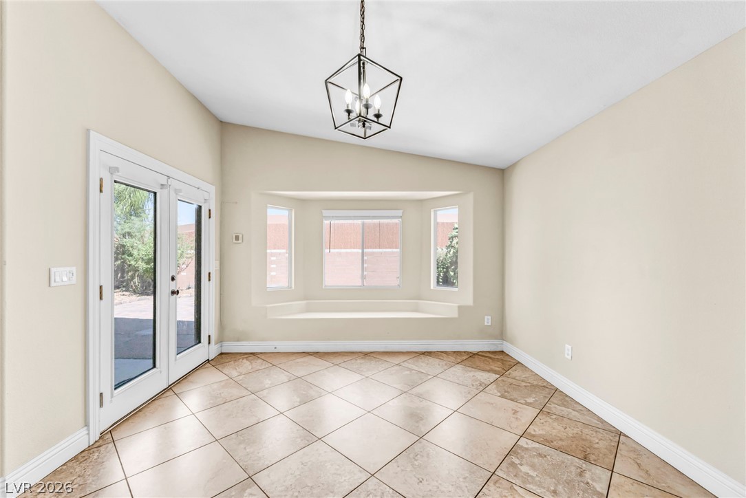 6405 North Raptor Court North Las Vegas, NV 89084 - Photo 19 of 66 A spacious room offers direct outdoor access through French doors and a charming bay window with a built-in seat.