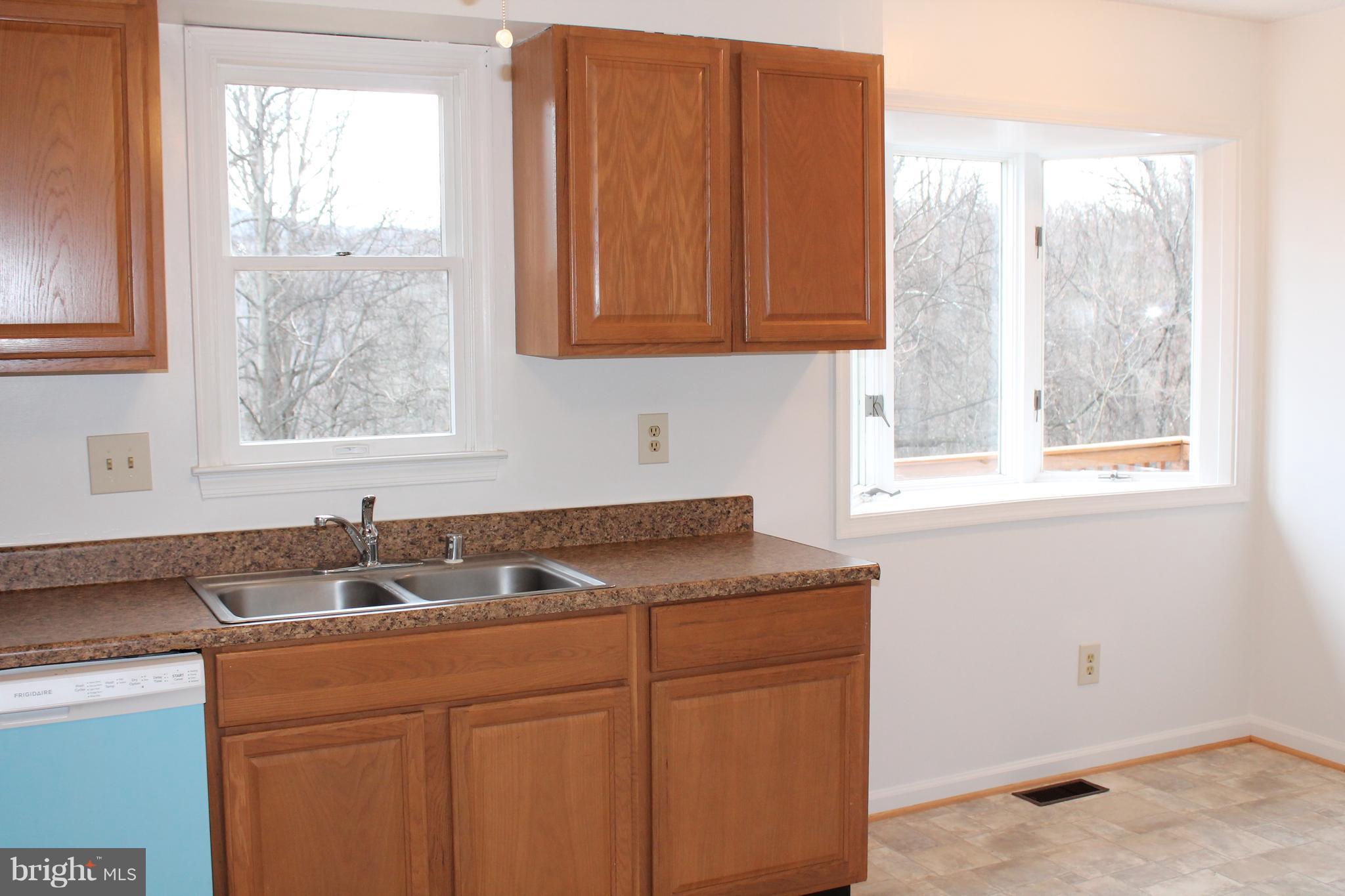 44 Hickory Tree Road Front Royal, VA 22630 - Photo 2 of 30 a kitchen with stainless steel appliances granite countertop white cabinets window and sink