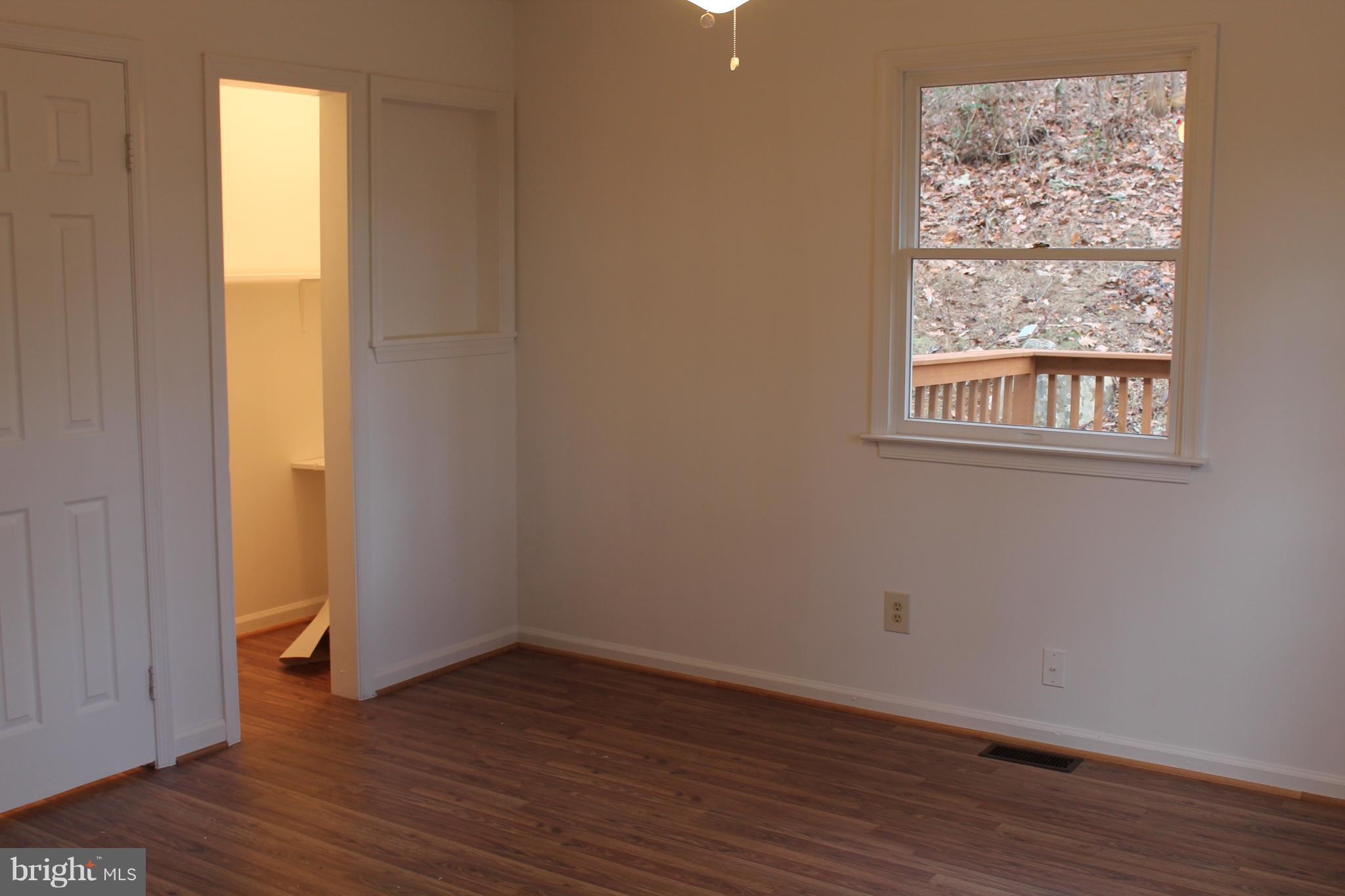 44 Hickory Tree Road Front Royal, VA 22630 - Photo 15 of 30 an empty room with wooden floor and windows