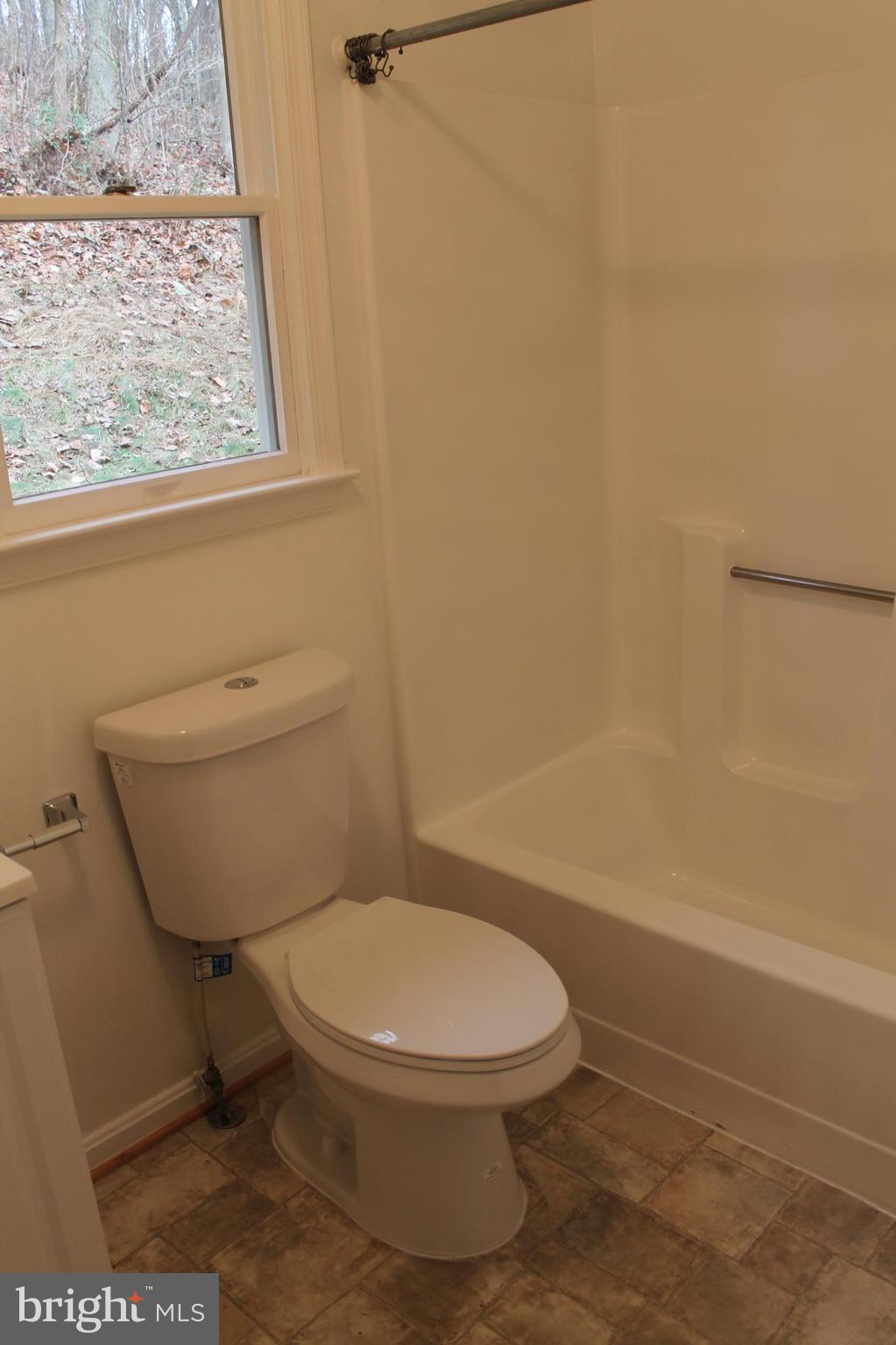 44 Hickory Tree Road Front Royal, VA 22630 - Photo 21 of 30 a white toilet sitting next to a bath tub and a shower
