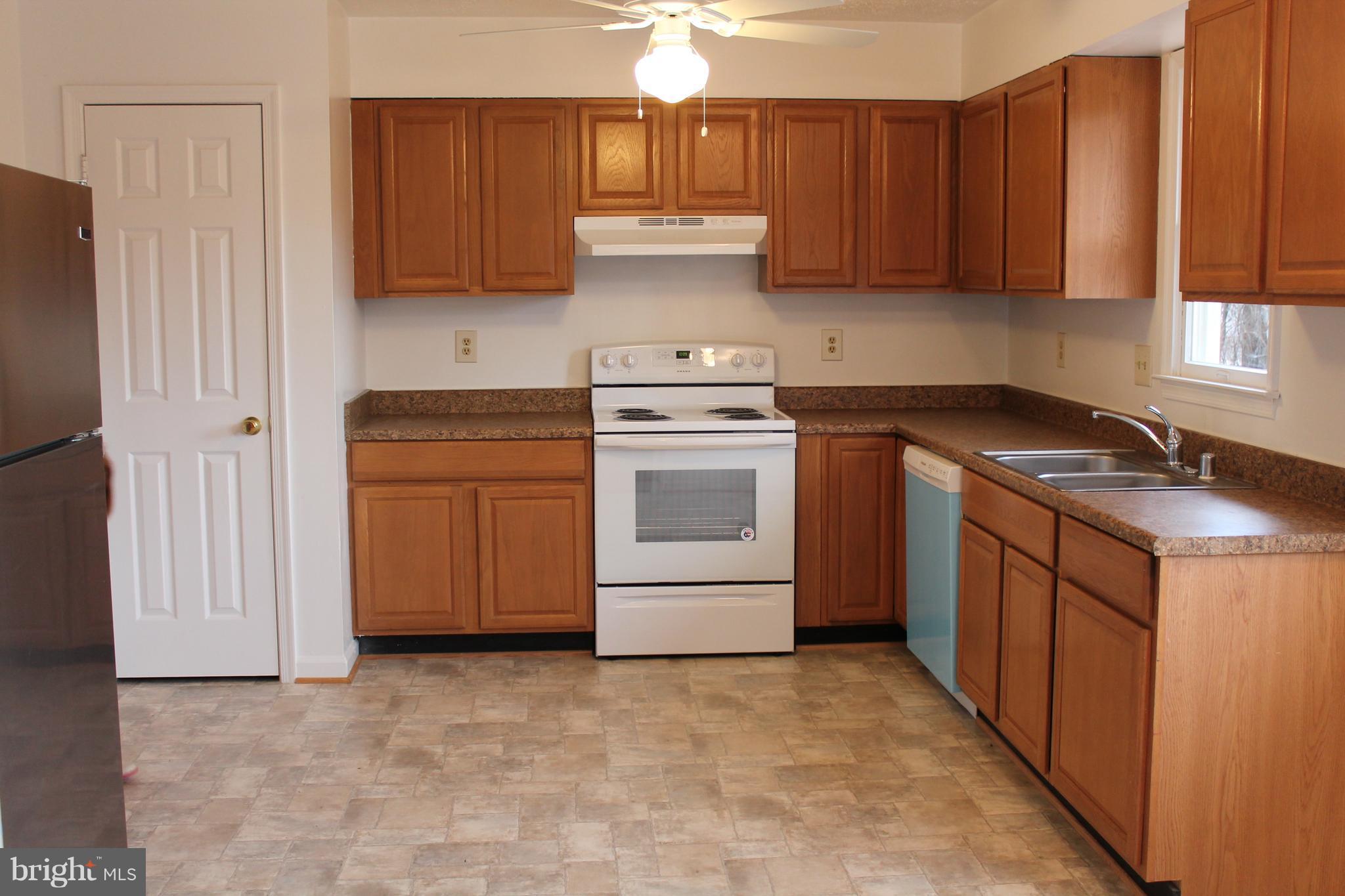 44 Hickory Tree Road Front Royal, VA 22630 - Photo 6 of 30 a kitchen with a stove sink and cabinets