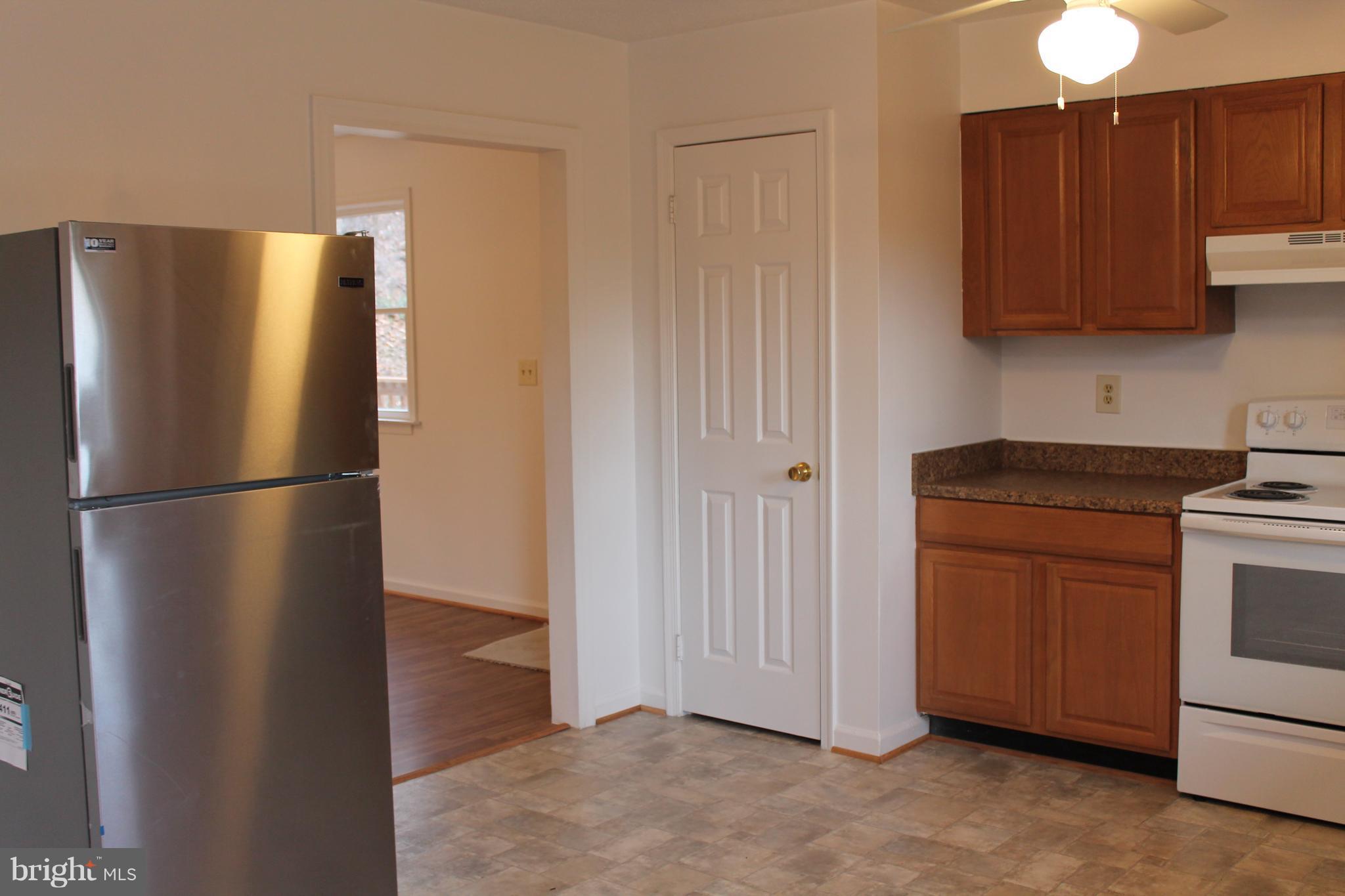 44 Hickory Tree Road Front Royal, VA 22630 - Photo 9 of 30 a kitchen with stainless steel appliances granite countertop a refrigerator a stove a sink and a cabinets