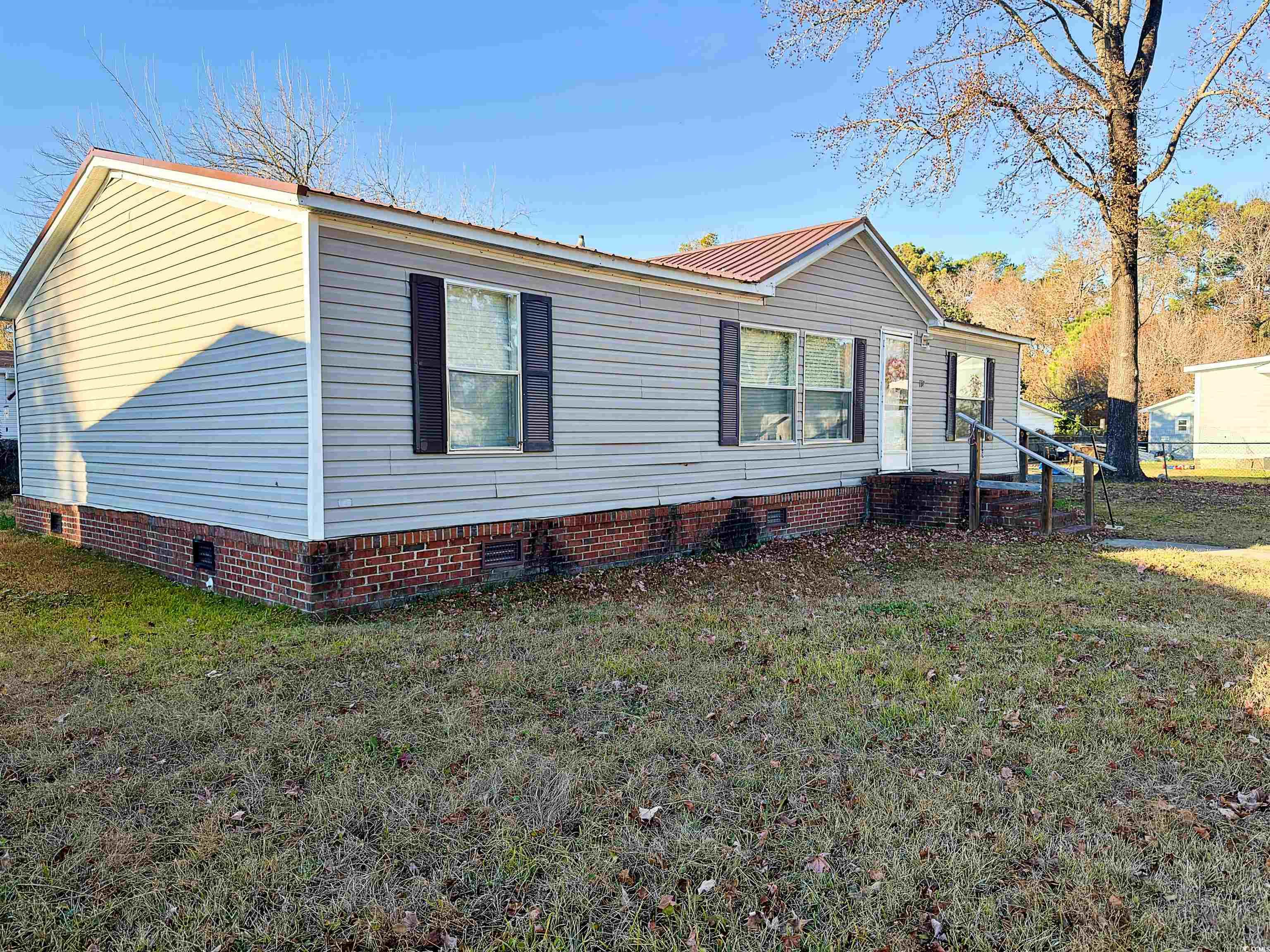 119 Ranchette Circle Myrtle Beach, SC 29588 - Photo 1 of 27 View of front of house with crawl space, a front yard, and a metal roof