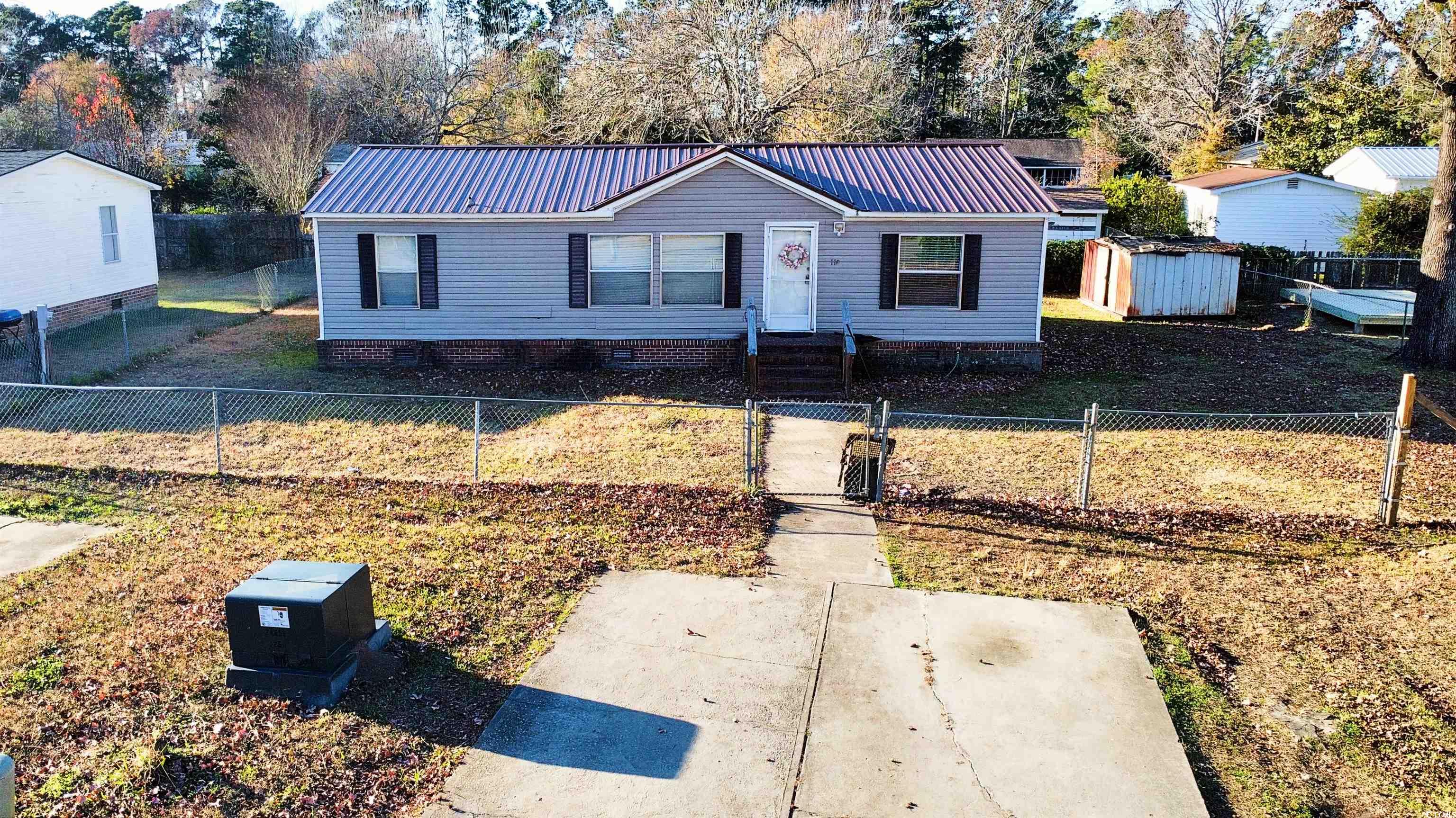 119 Ranchette Circle Myrtle Beach, SC 29588 - Photo 20 of 27 View of front of house with a metal roof, a fenced front yard, crawl space, a gate, and entry steps