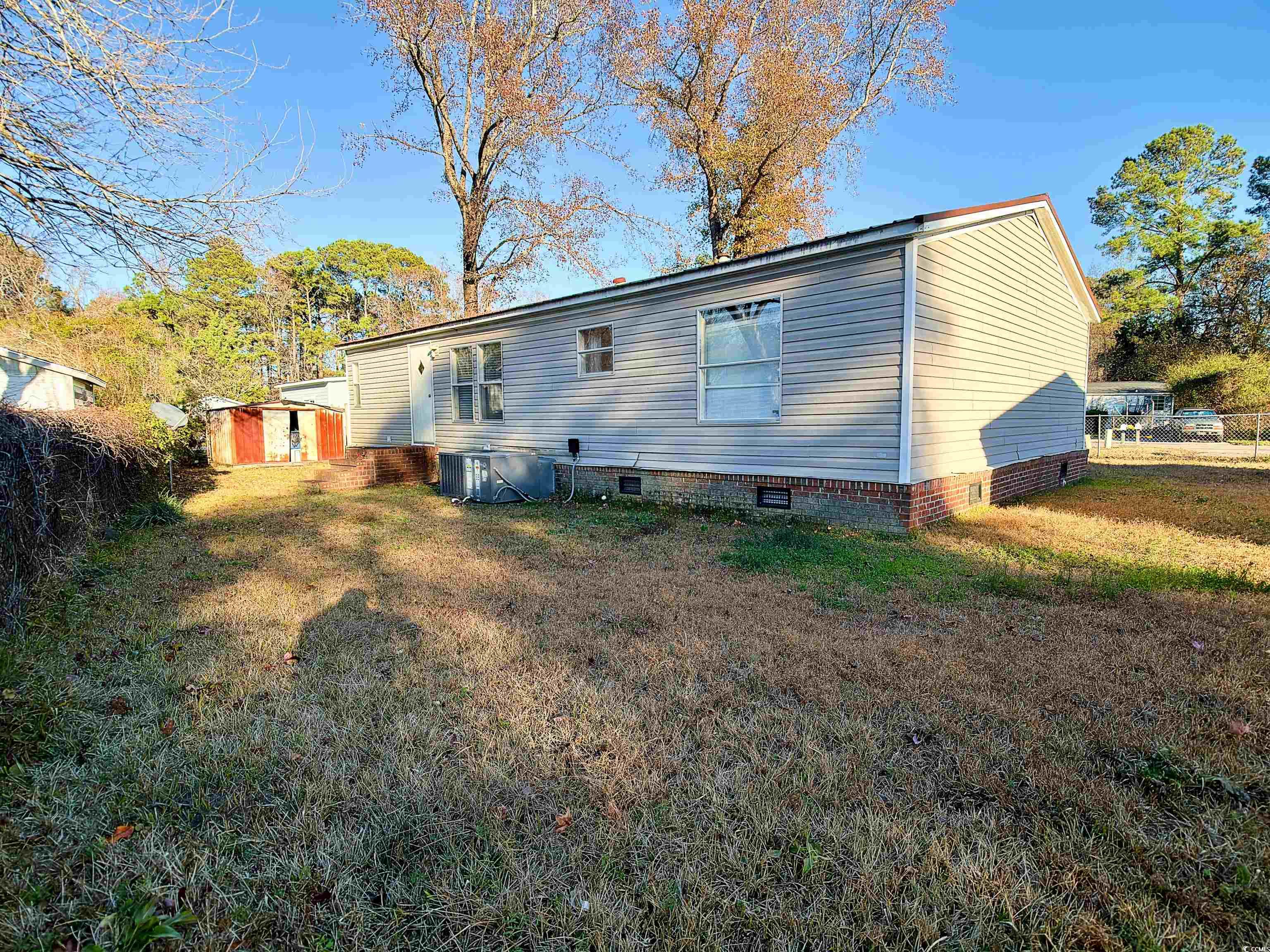 119 Ranchette Circle Myrtle Beach, SC 29588 - Photo 3 of 27 Back of house featuring a storage unit and crawl space