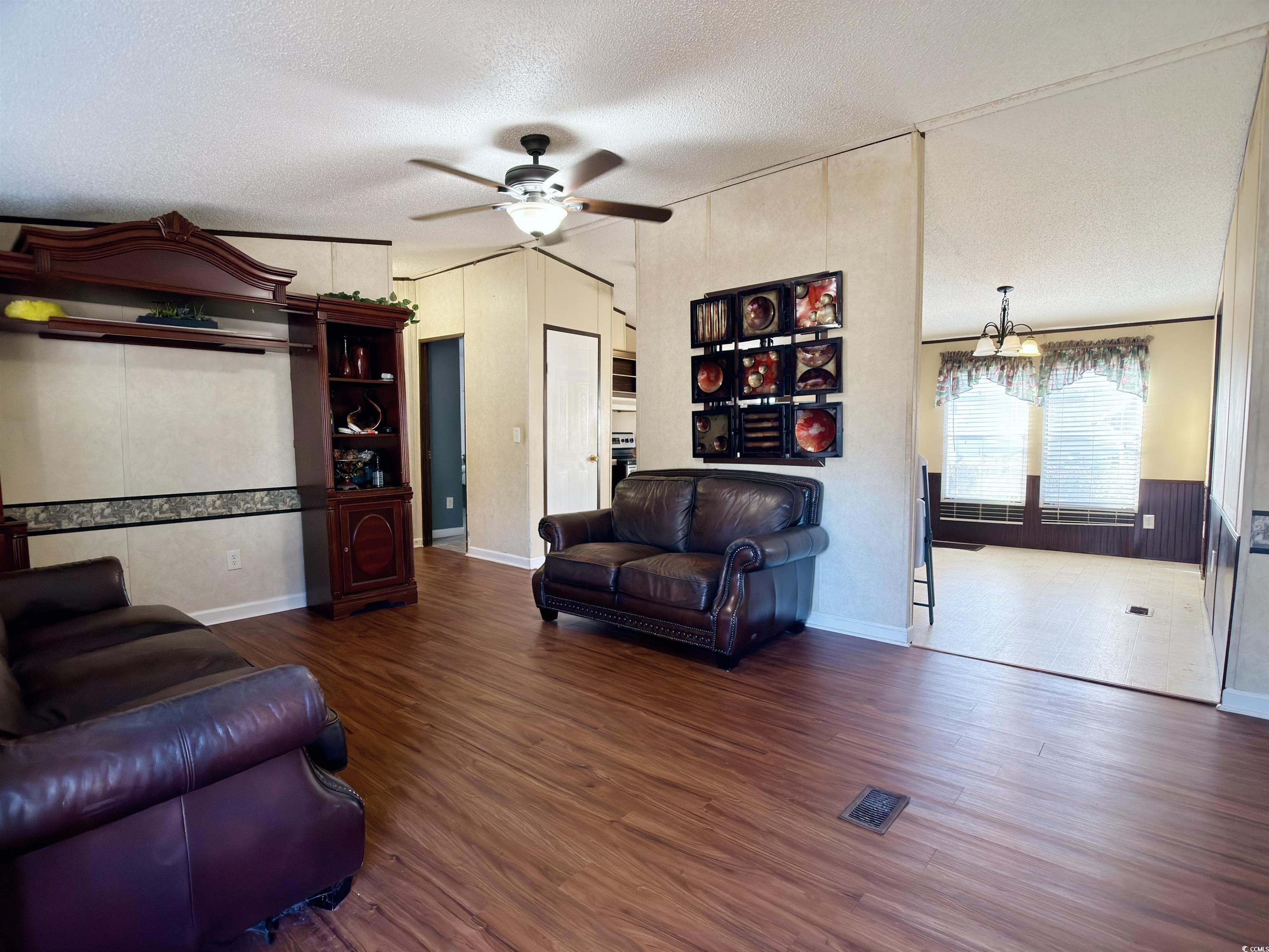 119 Ranchette Circle Myrtle Beach, SC 29588 - Photo 6 of 27 Living area with a textured ceiling, dark wood finished floors, and a ceiling fan