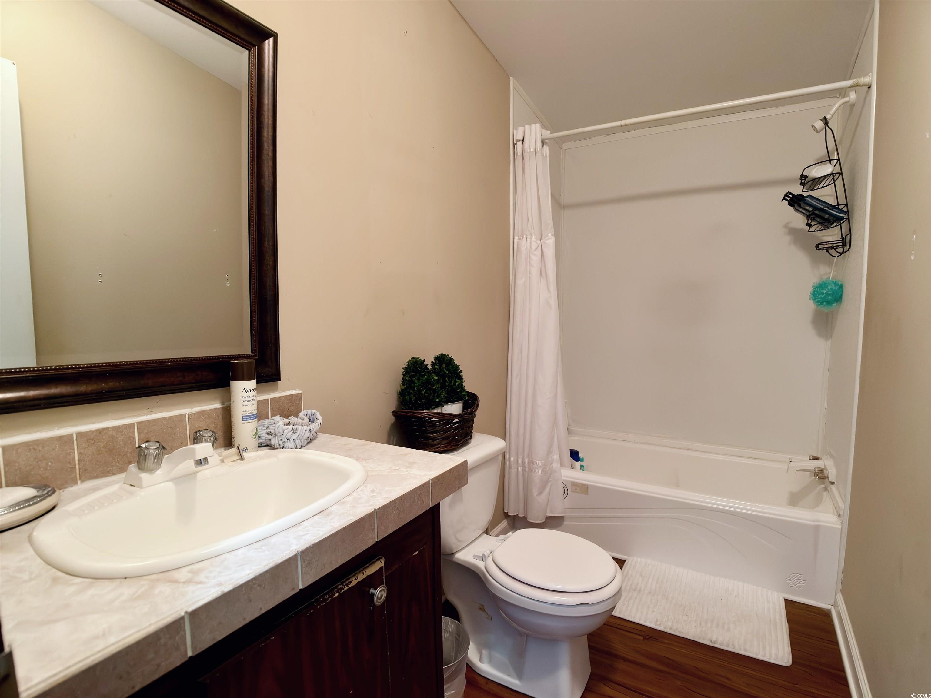 119 Ranchette Circle Myrtle Beach, SC 29588 - Photo 10 of 27 Full bathroom featuring shower / bath combination with curtain, vanity, and dark wood-style floors