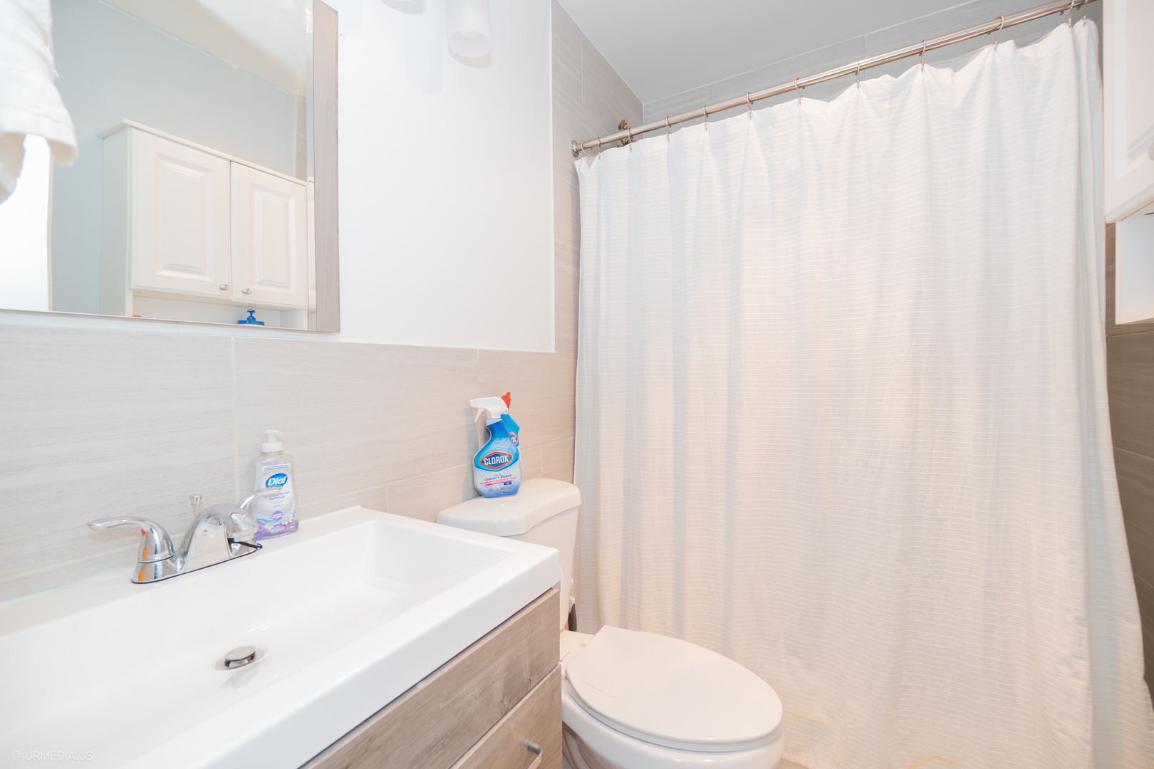 2201 North Cleveland Avenue, Unit 306 Chicago, IL 60614 - Photo 14 of 22 a bathroom with a sink a toilet and a mirror