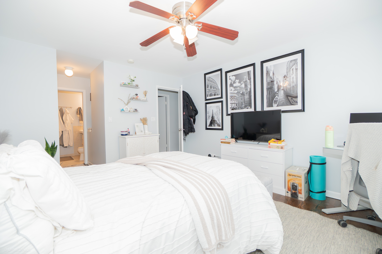 2201 North Cleveland Avenue, Unit 306 Chicago, IL 60614 - Photo 19 of 22 a bedroom with a bed a flat screen tv and a ceiling fan