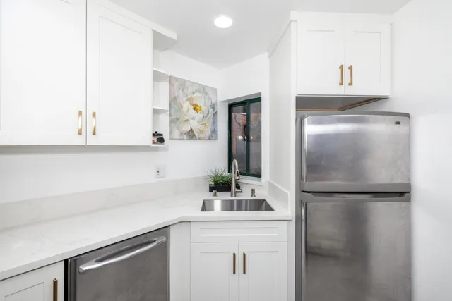 a kitchen with a sink and refrigerator