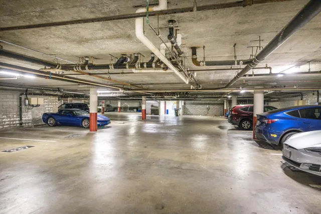 a view of parking garage with cars parked