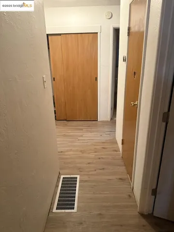 a view of hallway with wooden floor