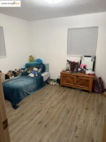 a bedroom with a bed and a mirror