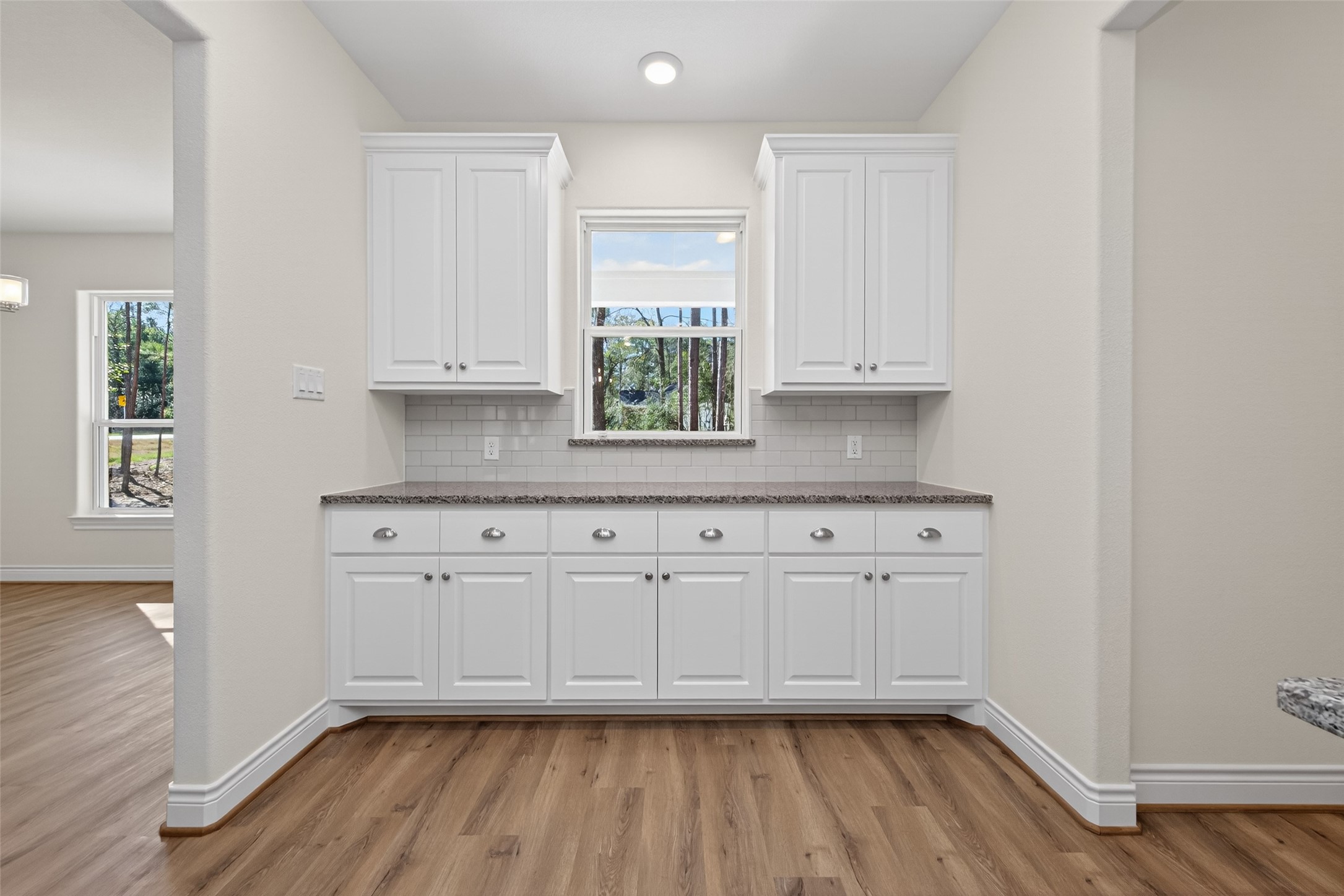 12879 Oak Barrel Road Willis, TX 77378 - Photo 13 of 37 a kitchen with granite countertop white cabinets and white appliances