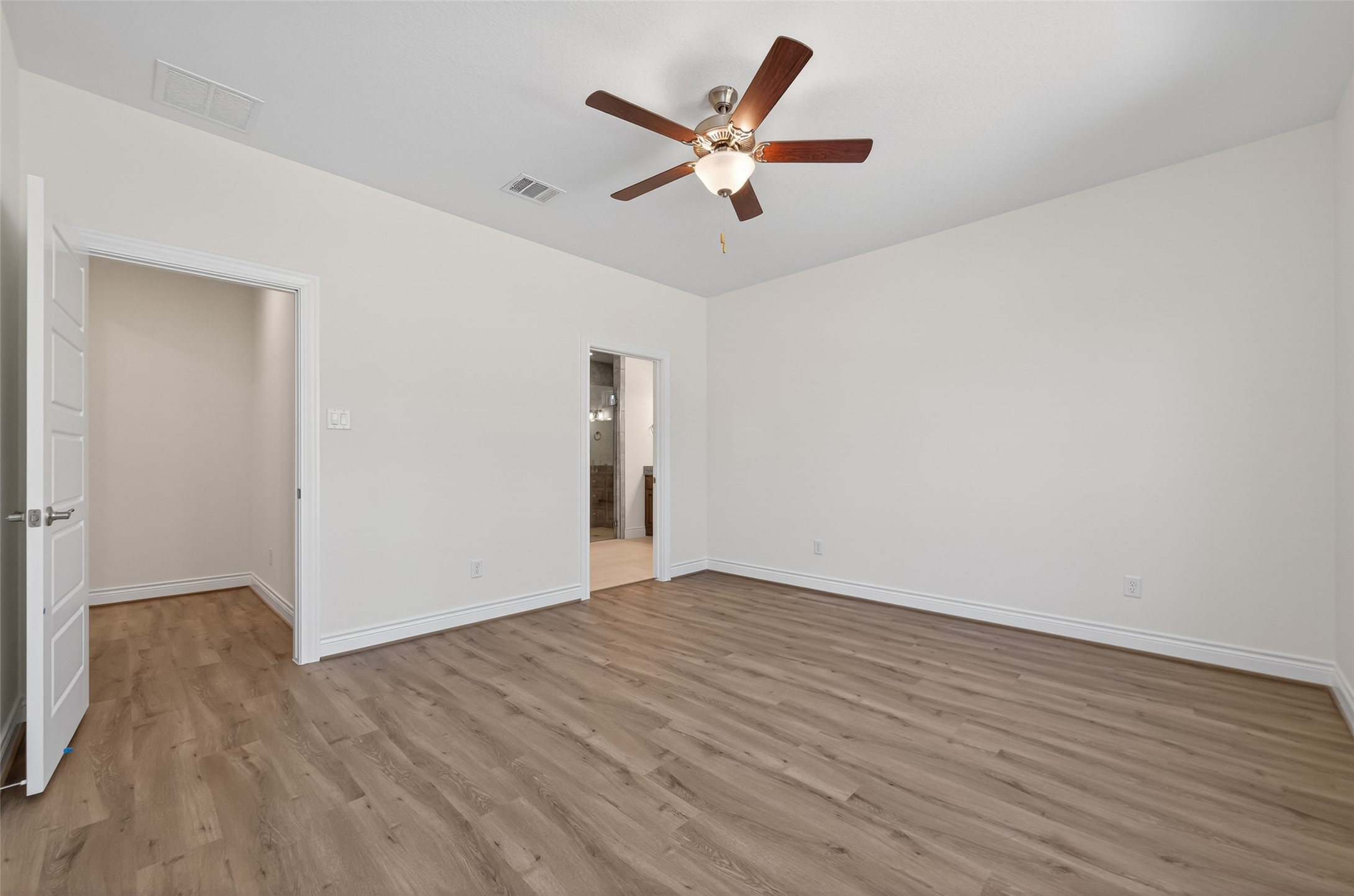 12879 Oak Barrel Road Willis, TX 77378 - Photo 15 of 37 an empty room with wooden floor ceiling fan and windows
