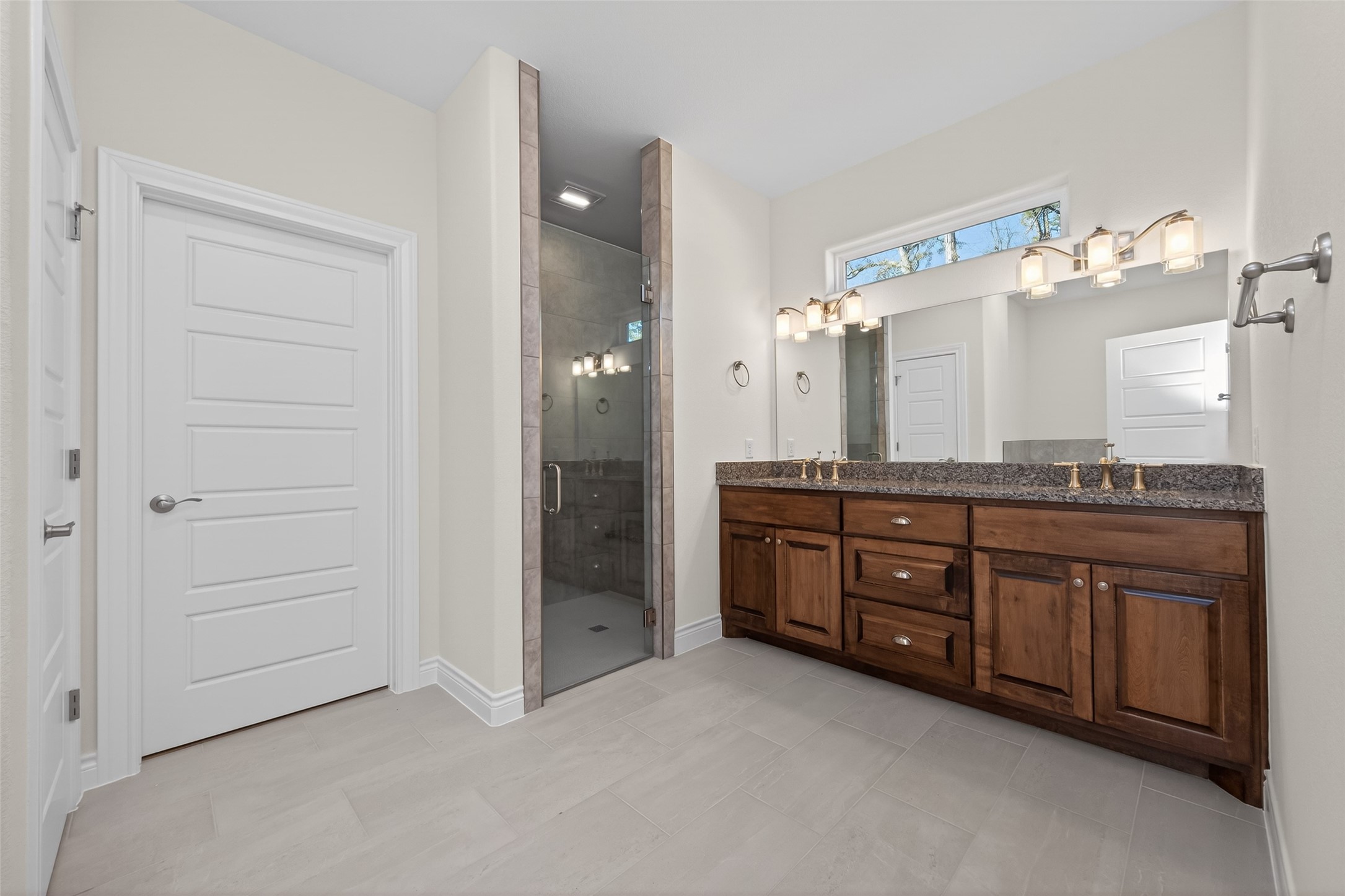 12879 Oak Barrel Road Willis, TX 77378 - Photo 18 of 37 a spacious bathroom with a granite countertop sink and a mirror