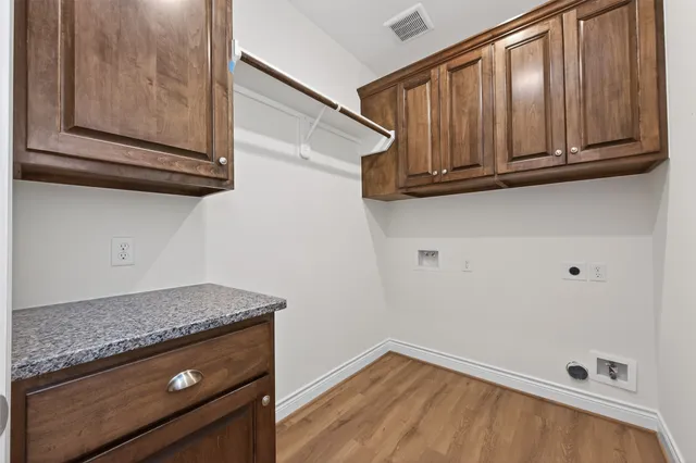 a view of a kitchen with wooden cabinet