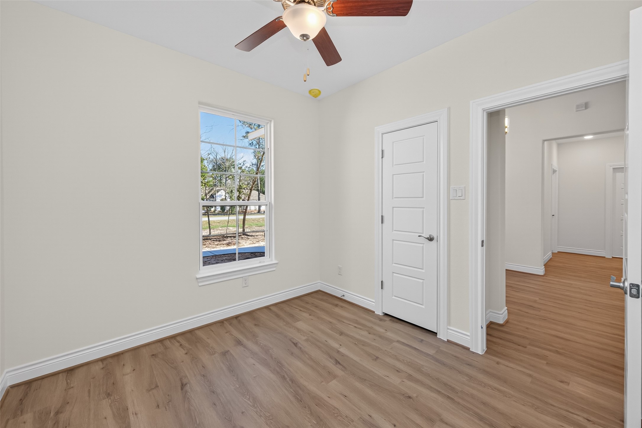 12879 Oak Barrel Road Willis, TX 77378 - Photo 25 of 37 a view of an empty room with wooden floor and a window