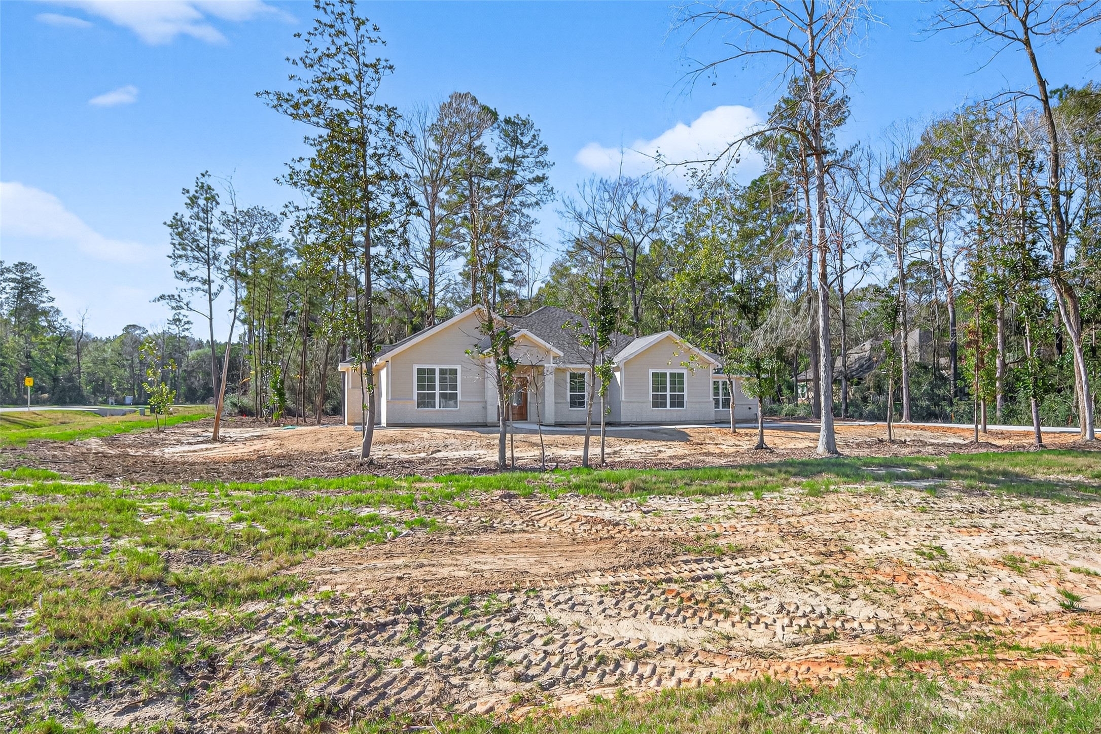 12879 Oak Barrel Road Willis, TX 77378 - Photo 3 of 37 a front view of a house with a yard and trees