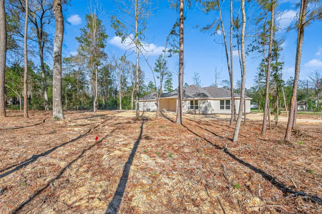 a view of a backyard with wooden fence