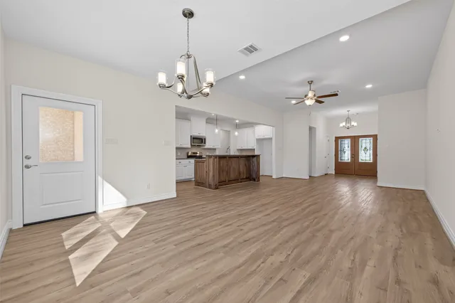 a view of a livingroom with a furniture wooden floor and chandelier