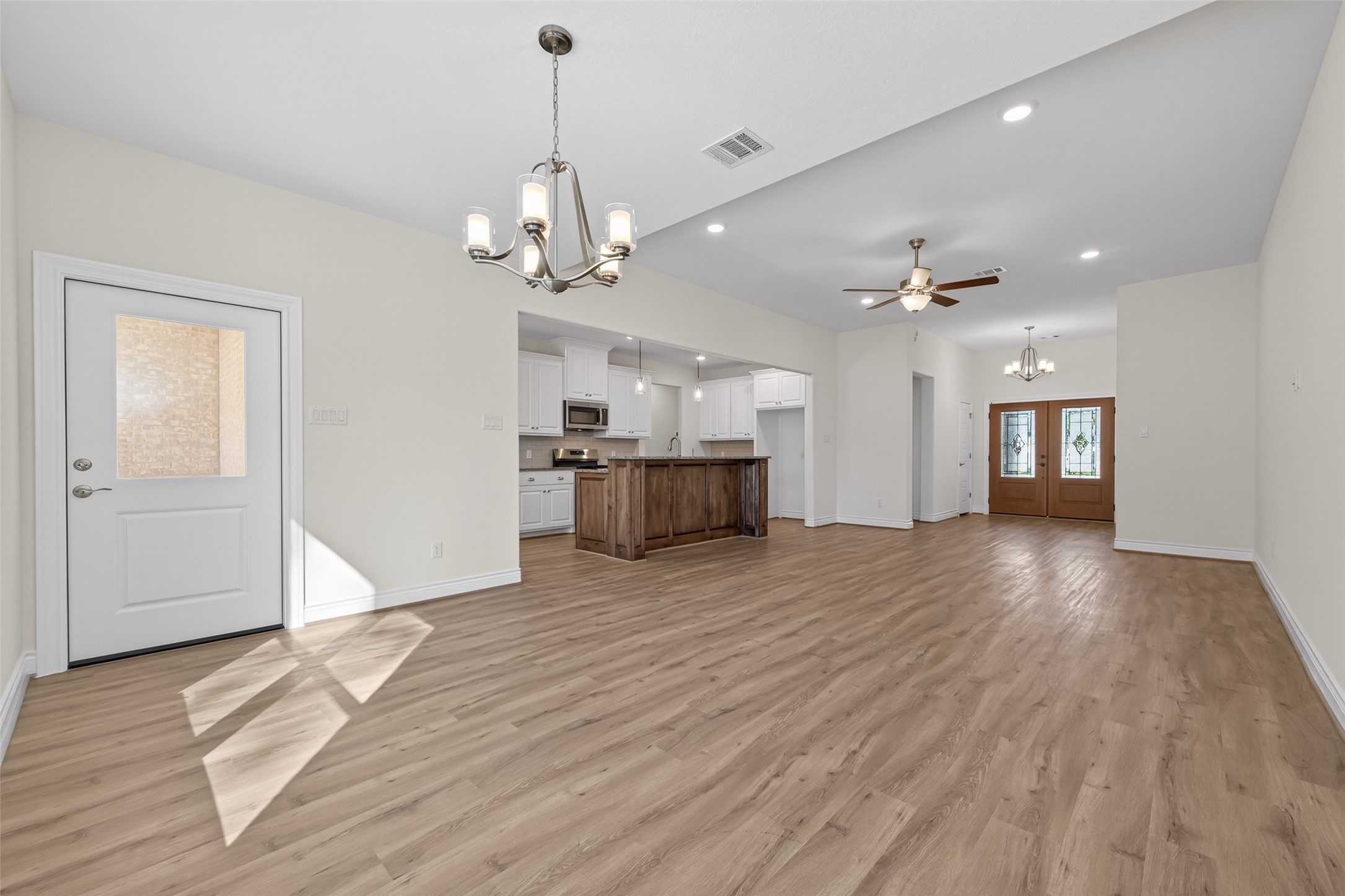12879 Oak Barrel Road Willis, TX 77378 - Photo 7 of 37 a view of a livingroom with a furniture wooden floor and chandelier