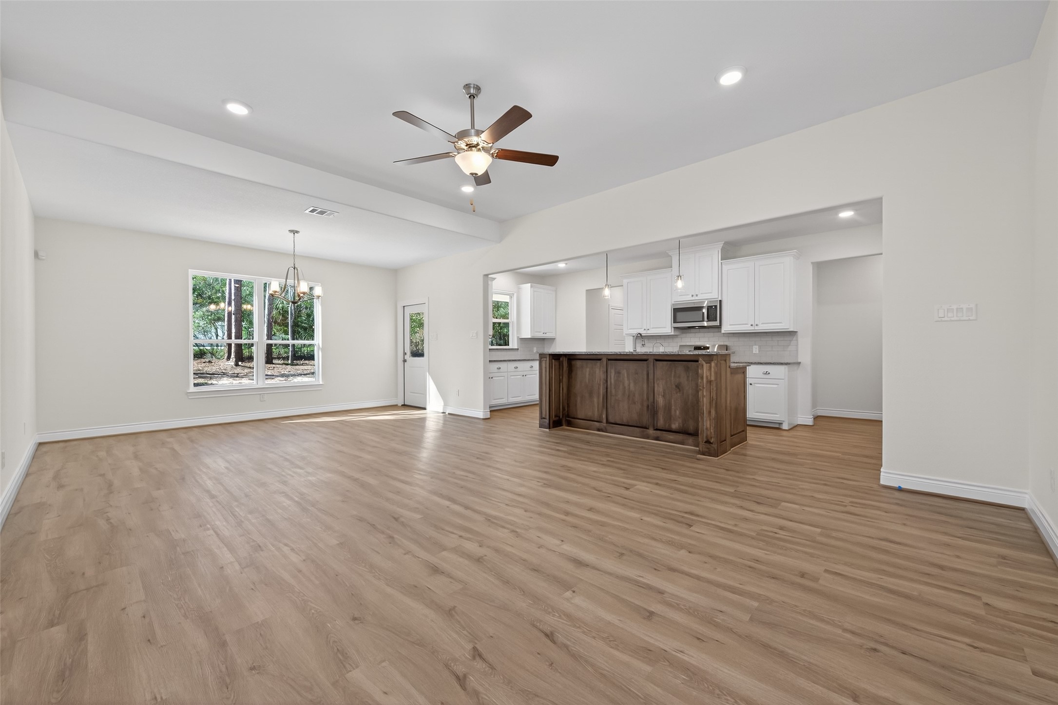 12879 Oak Barrel Road Willis, TX 77378 - Photo 8 of 37 a view of an empty room with window and wooden floor