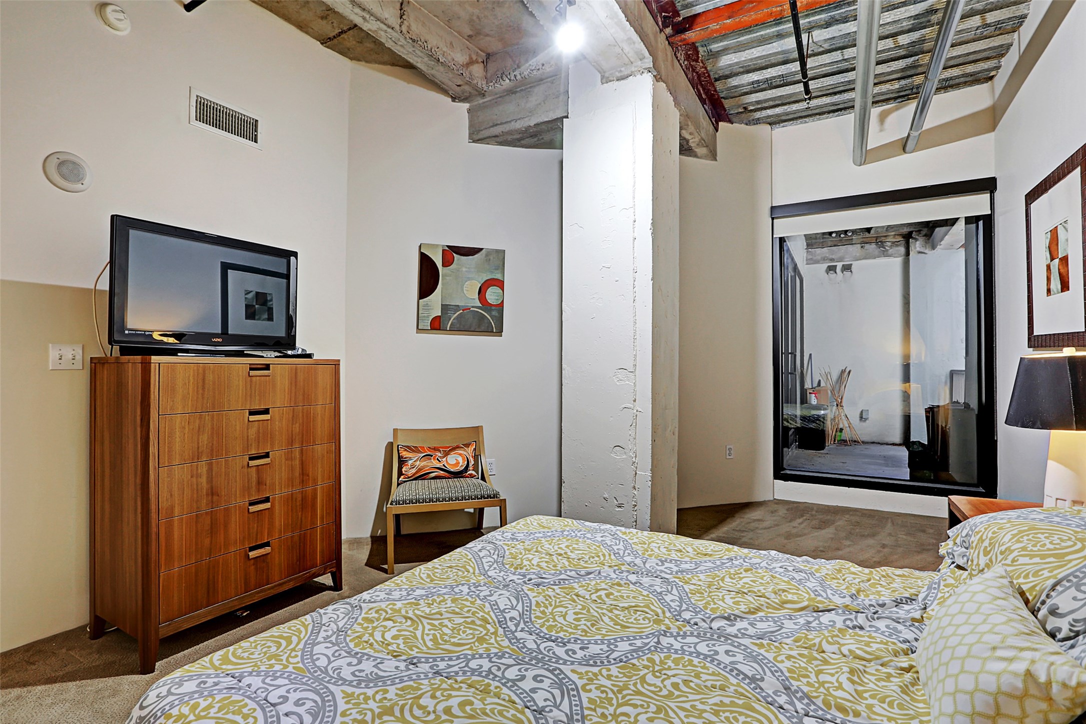 917 Main Street, Unit 503 Houston, TX 77002 - Photo 14 of 31 a bedroom with a bed and a flat tv screen on dresser