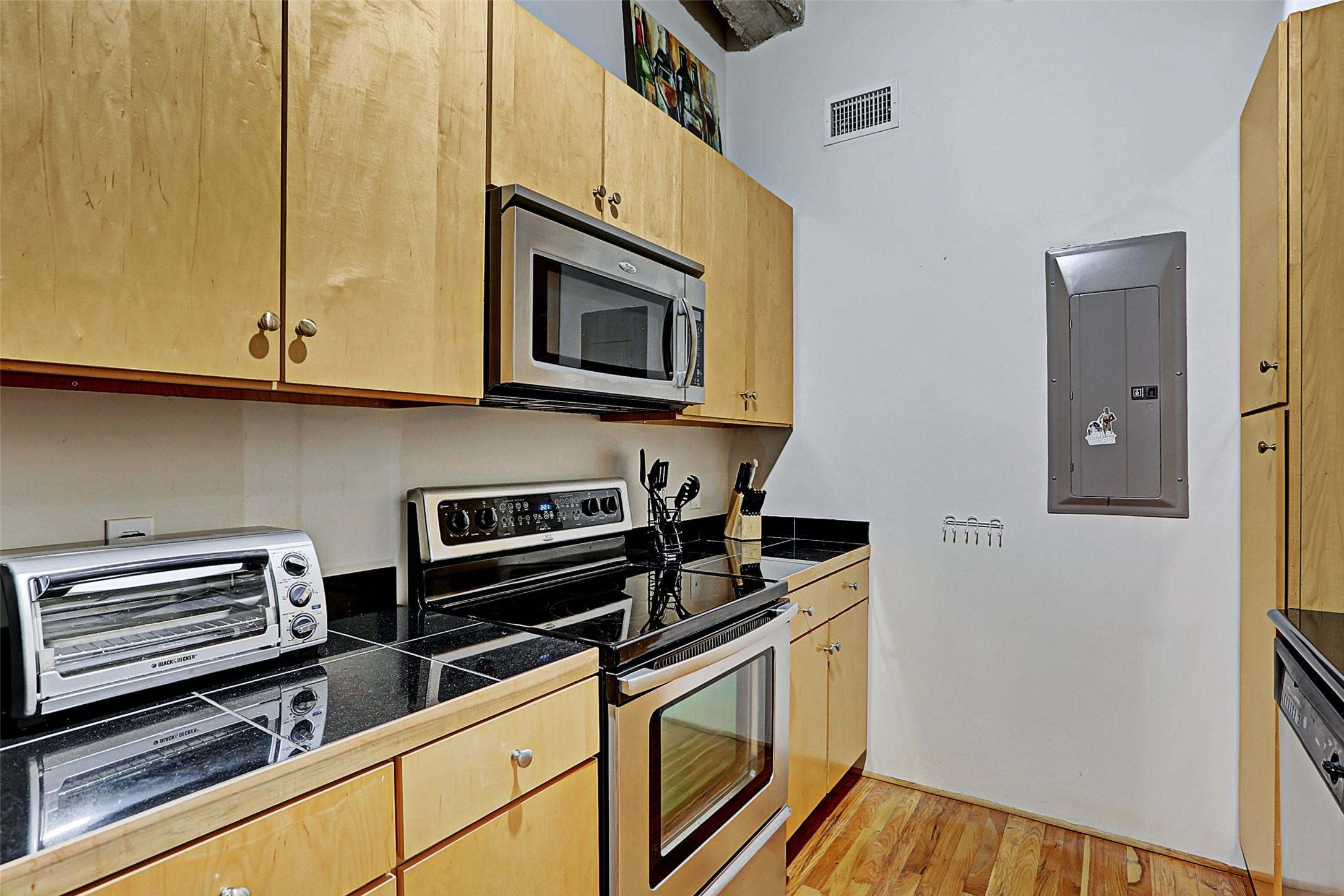 917 Main Street, Unit 503 Houston, TX 77002 - Photo 10 of 31 a kitchen with stainless steel appliances granite countertop a stove and a microwave