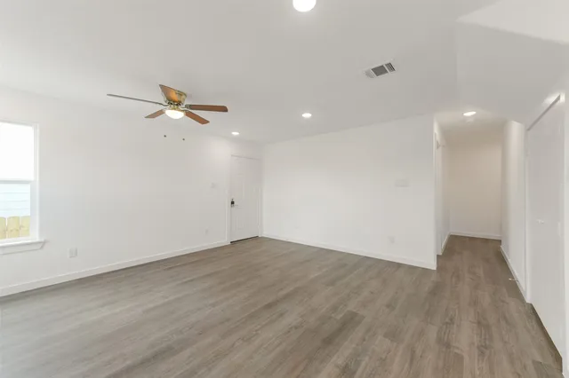 wooden floor in an empty room with a window