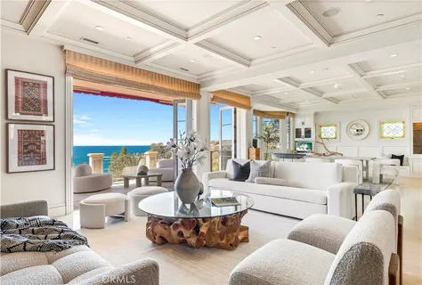 a living room with patio furniture and a large window