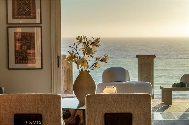 a living room with furniture a chandelier and a flat screen tv