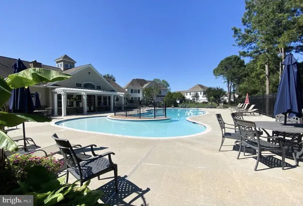a view of a house with swimming pool and sitting area