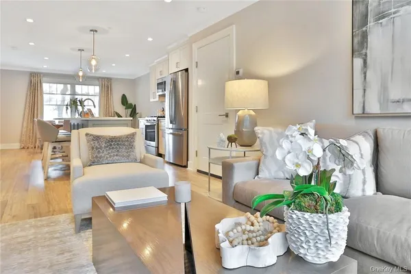 a living room with furniture and a chandelier