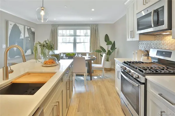 a kitchen with a table chairs stove and cabinets