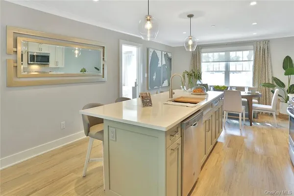 a kitchen with sink cabinets and wooden floor