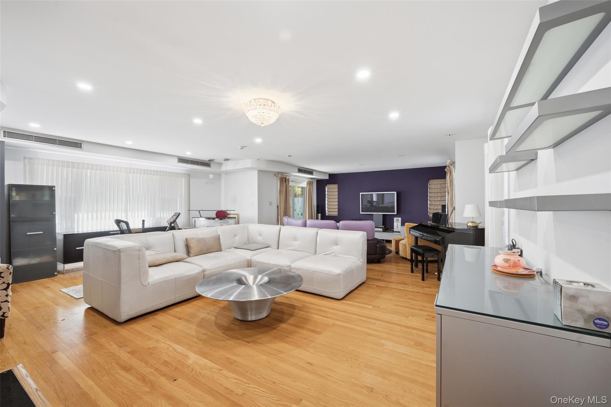 a living room with furniture and a kitchen view