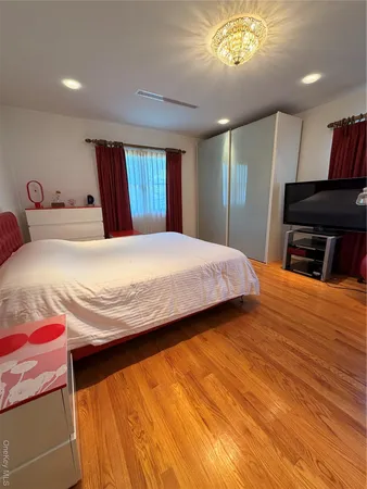a bedroom with a bed and a television