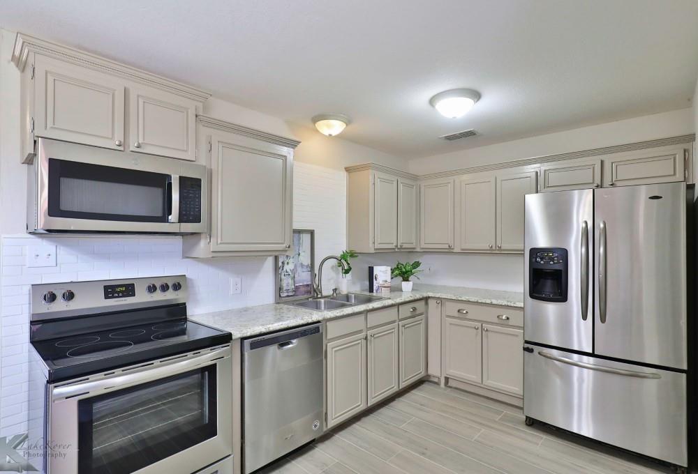 4418 Bob O Link Drive Abilene, TX 79606 - Photo 1 of 40 a kitchen with a sink stove and microwave