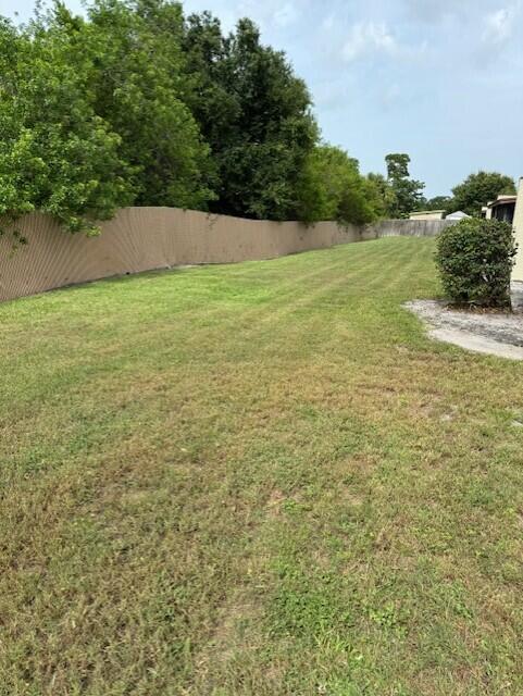6014 Indrio Road, Unit F2 Fort Pierce, FL 34951 - Photo 23 of 27 a view of a field with an trees