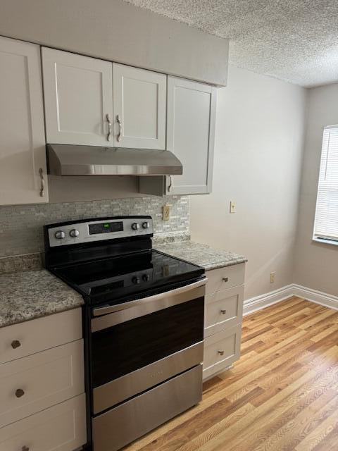 6014 Indrio Road, Unit F2 Fort Pierce, FL 34951 - Photo 4 of 27 a kitchen with granite countertop white cabinets appliances and a sink